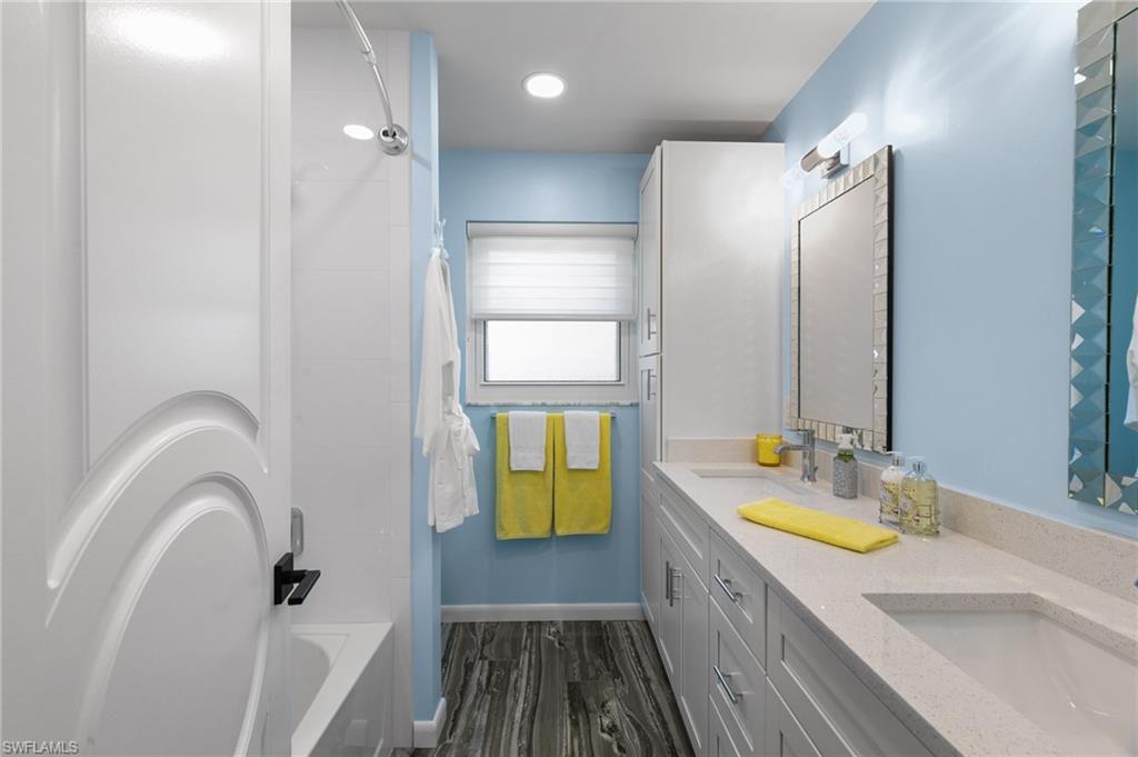 230 Pine Valley Circle Naples, FL 34113 - Photo 24 of 40 a bathroom with a granite countertop sink and a tub