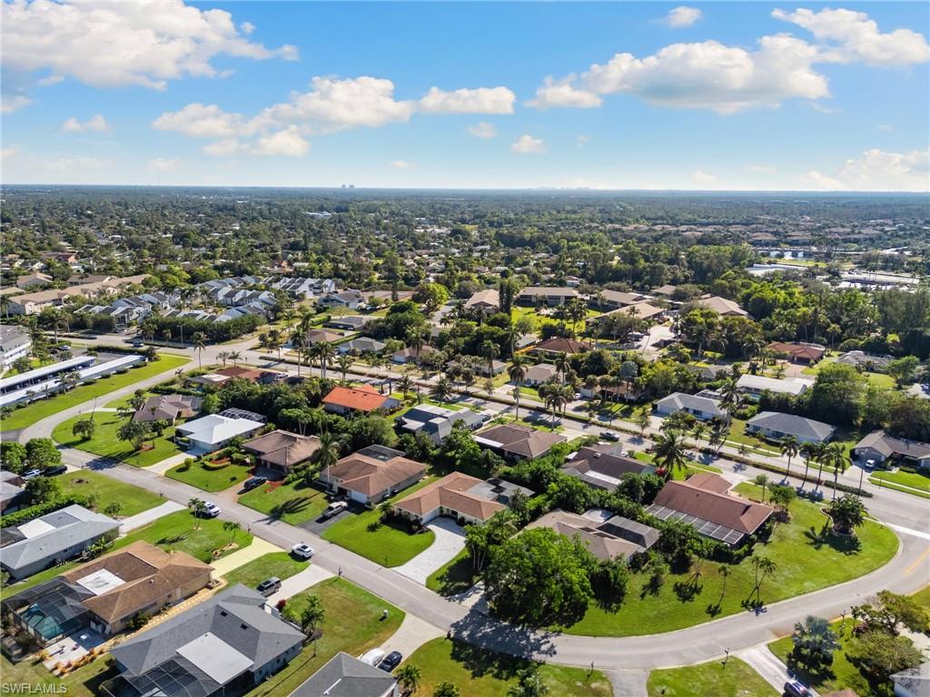 230 Pine Valley Circle Naples, FL 34113 - Photo 39 of 40 an aerial view of residential houses with yard