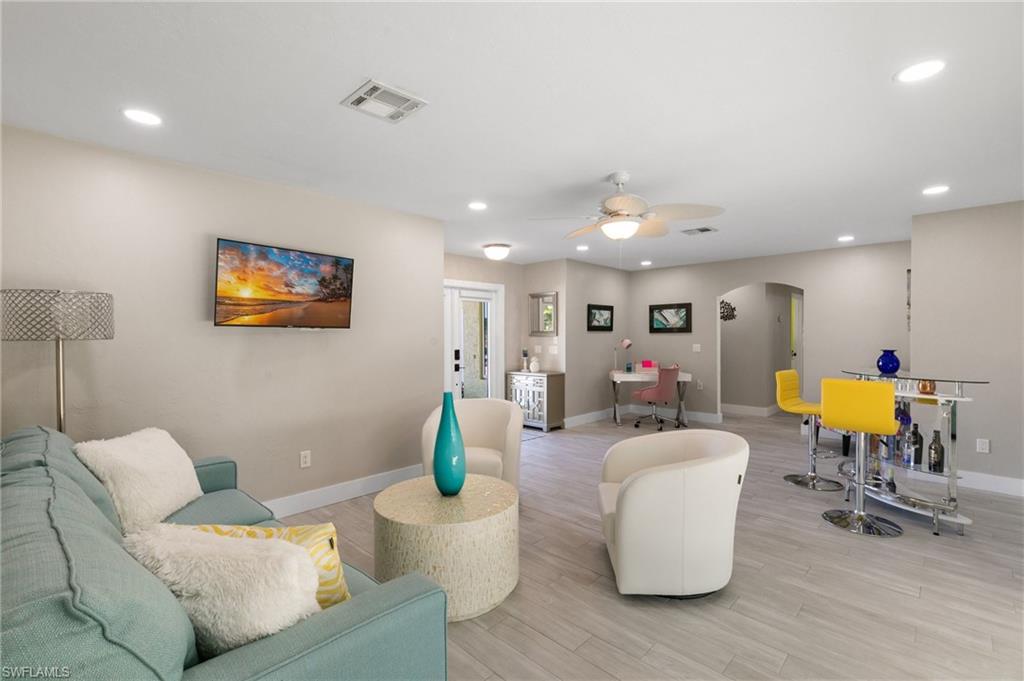 230 Pine Valley Circle Naples, FL 34113 - Photo 5 of 40 a living room with furniture and a dining table