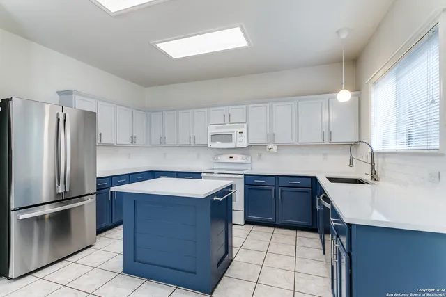 a kitchen with a sink stove and refrigerator