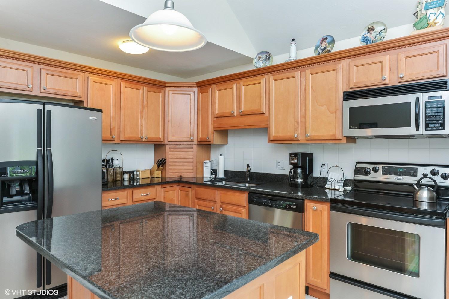 23 Gold Leaf Lane Mashpee, MA 02649 - Photo 6 of 15 a kitchen with stainless steel appliances granite countertop a sink a microwave stove and refrigerator