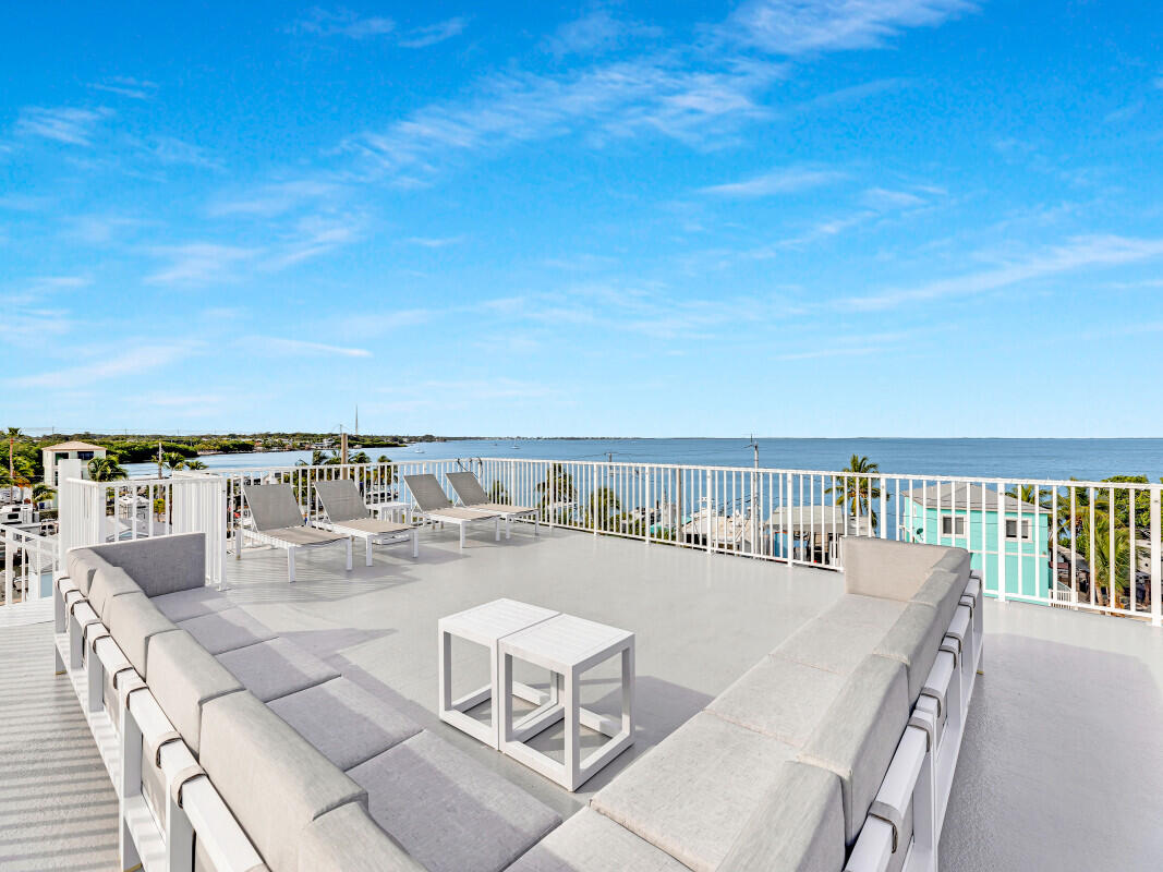 325 Calusa Street, Unit 359 Key Largo, FL 33037 - Photo 30 of 52 a balcony with a table and chairs