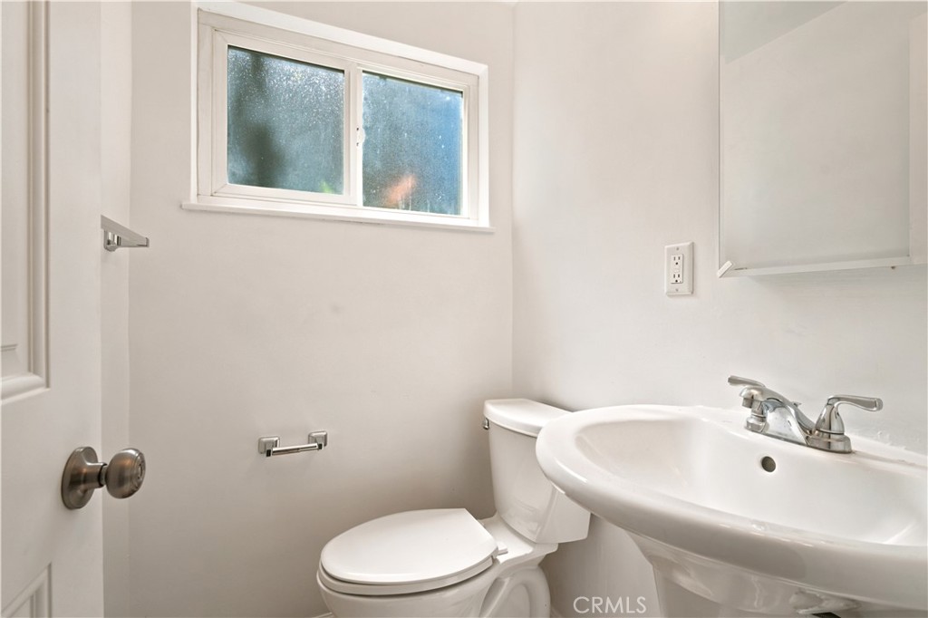 1720 Anderson Street Simi Valley, CA 93065 - Photo 10 of 30 a white toilet sitting next to a bathroom sink