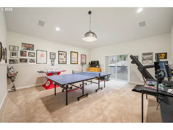 a living room with furniture a air conditioner and a wooden floor