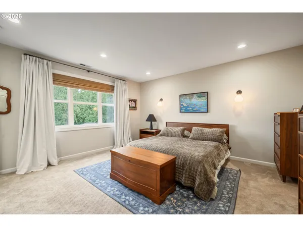 a bed room with a bed window and a television