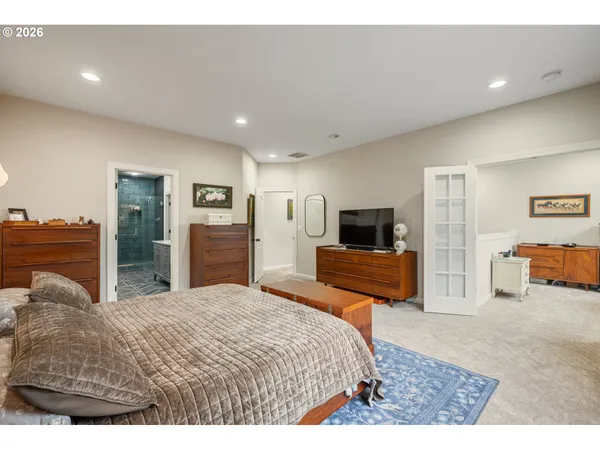a bedroom with furniture and a flat screen tv