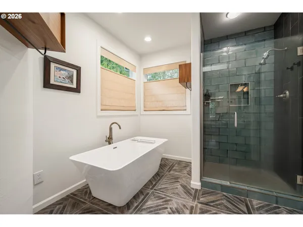 a bathroom with a sink mirror and shower