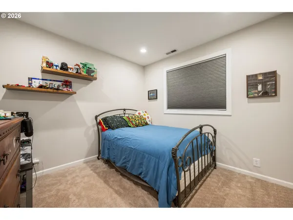 a bedroom with furniture and a flat screen tv