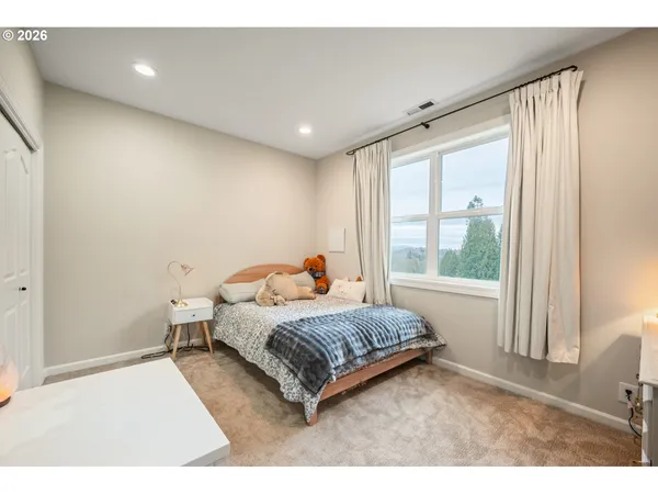 a living room with a bed furniture and a large window