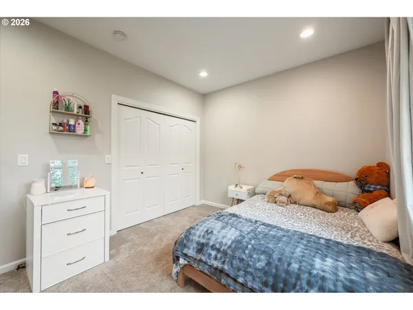 a bedroom with a bed and a dresser