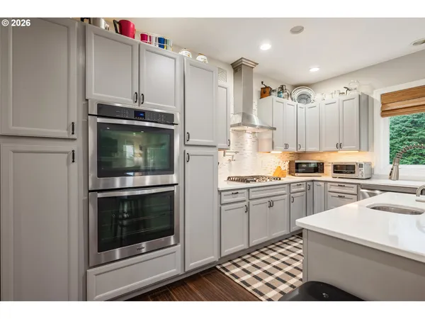 a kitchen with a sink cabinets and stainless steel appliances