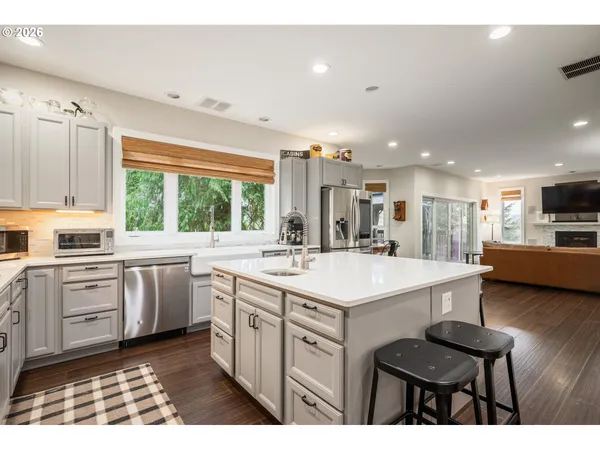 a kitchen with a sink stove and white cabinets