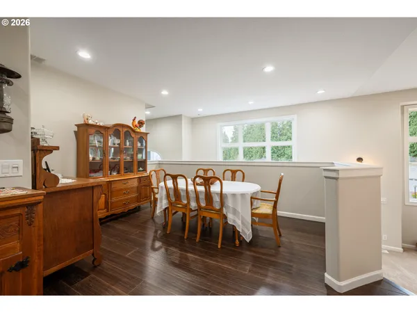 a dining room with furniture and wooden floor