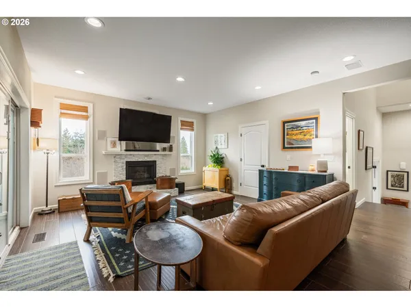 a living room with furniture a fireplace and a flat screen tv