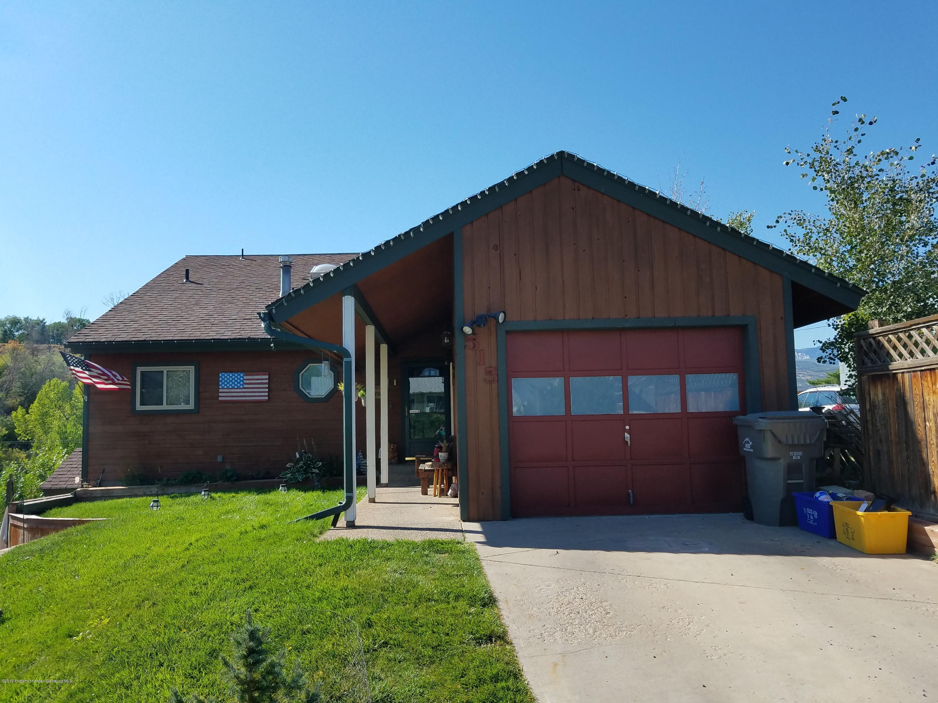 515 East 11th Street Rifle, CO 81650 - Photo 1 of 23 a front view of a house with a yard