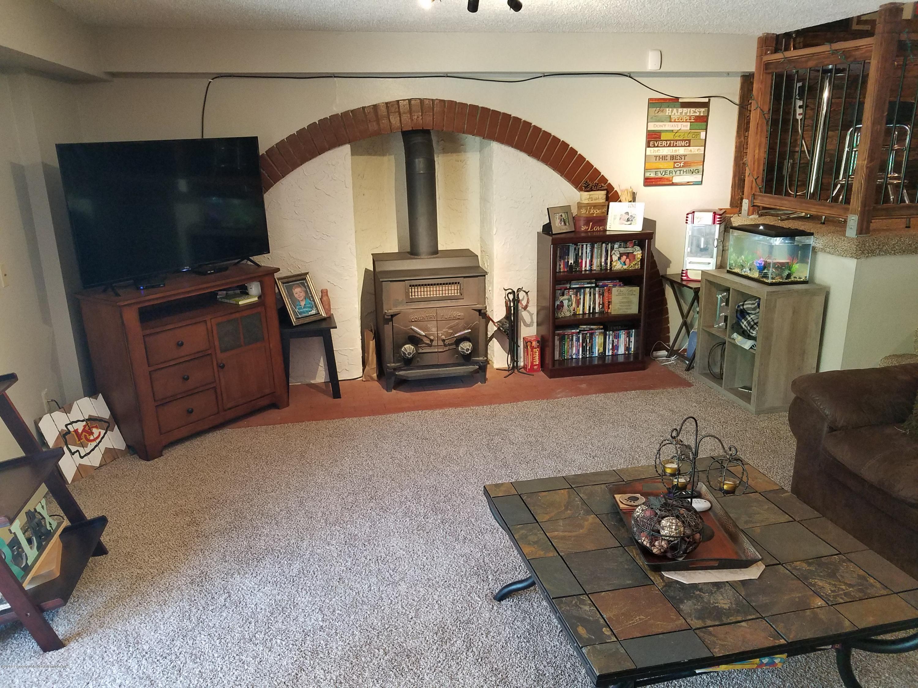 515 East 11th Street Rifle, CO 81650 - Photo 12 of 23 a living room with furniture and a flat screen tv