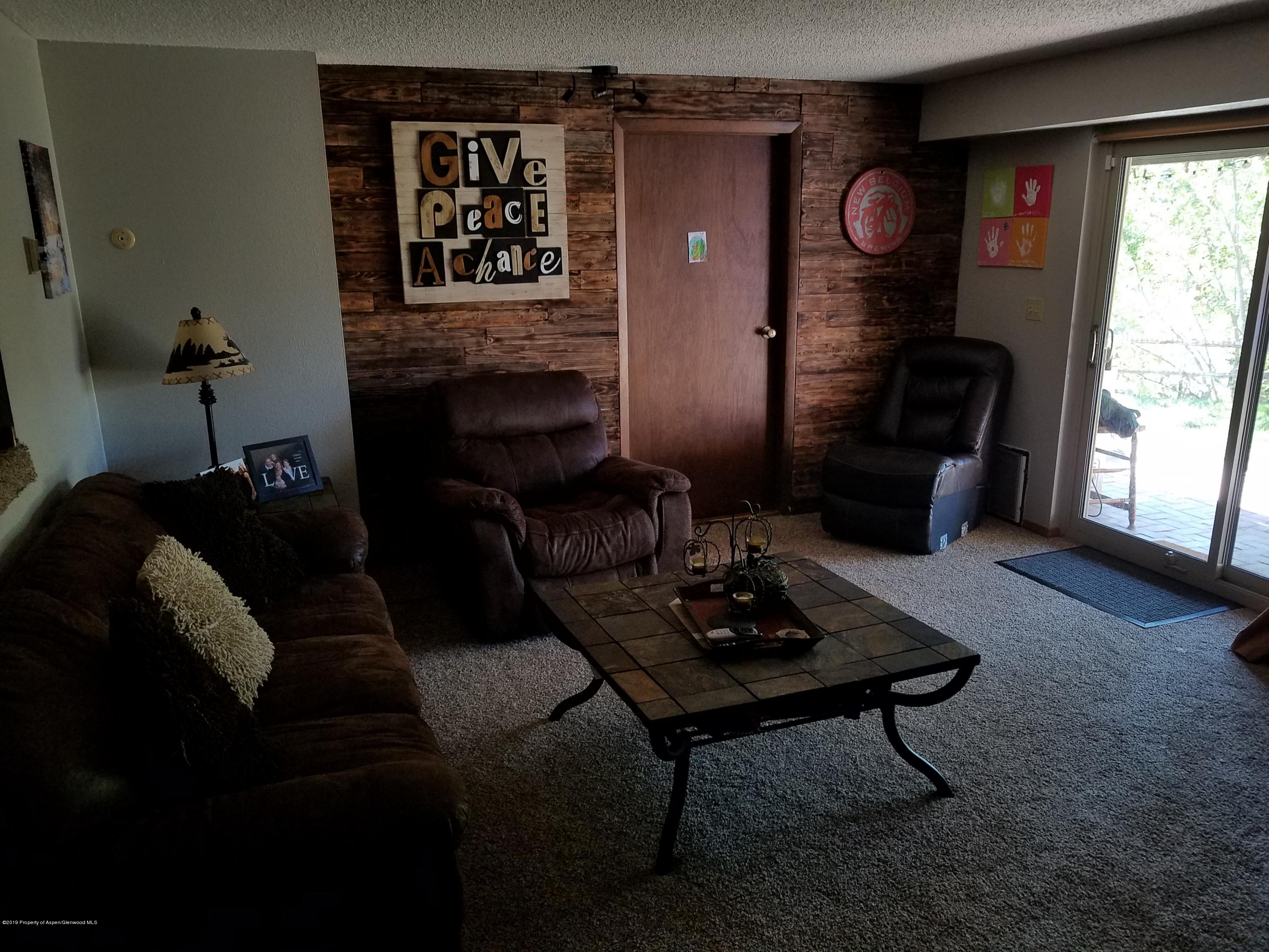 515 East 11th Street Rifle, CO 81650 - Photo 13 of 23 a living room with furniture and a fireplace