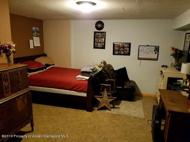 515 East 11th Street Rifle, CO 81650 - Photo 17 of 23 a bedroom with a bed and furniture