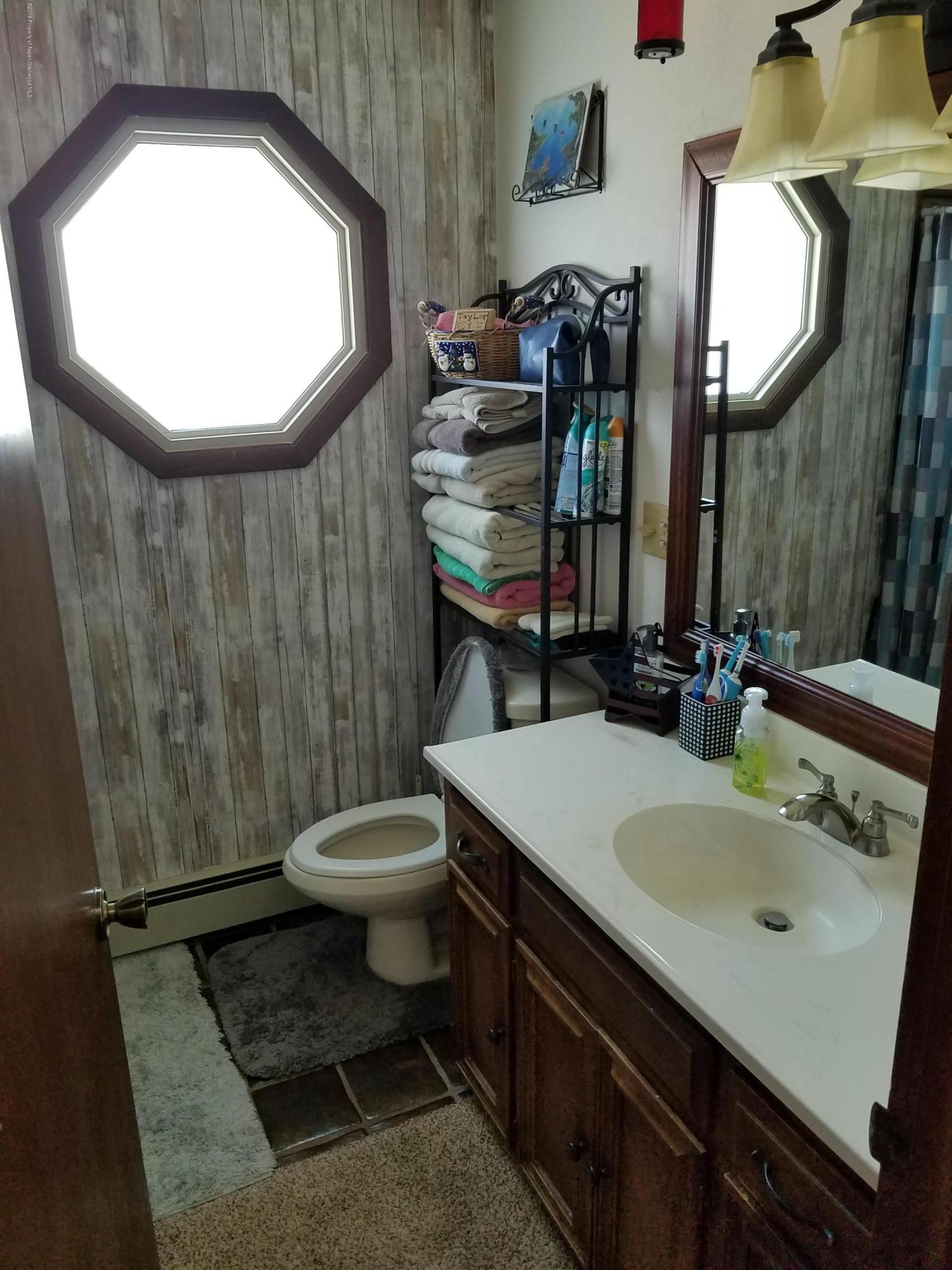 515 East 11th Street Rifle, CO 81650 - Photo 20 of 23 a bathroom with a sink toilet and mirror