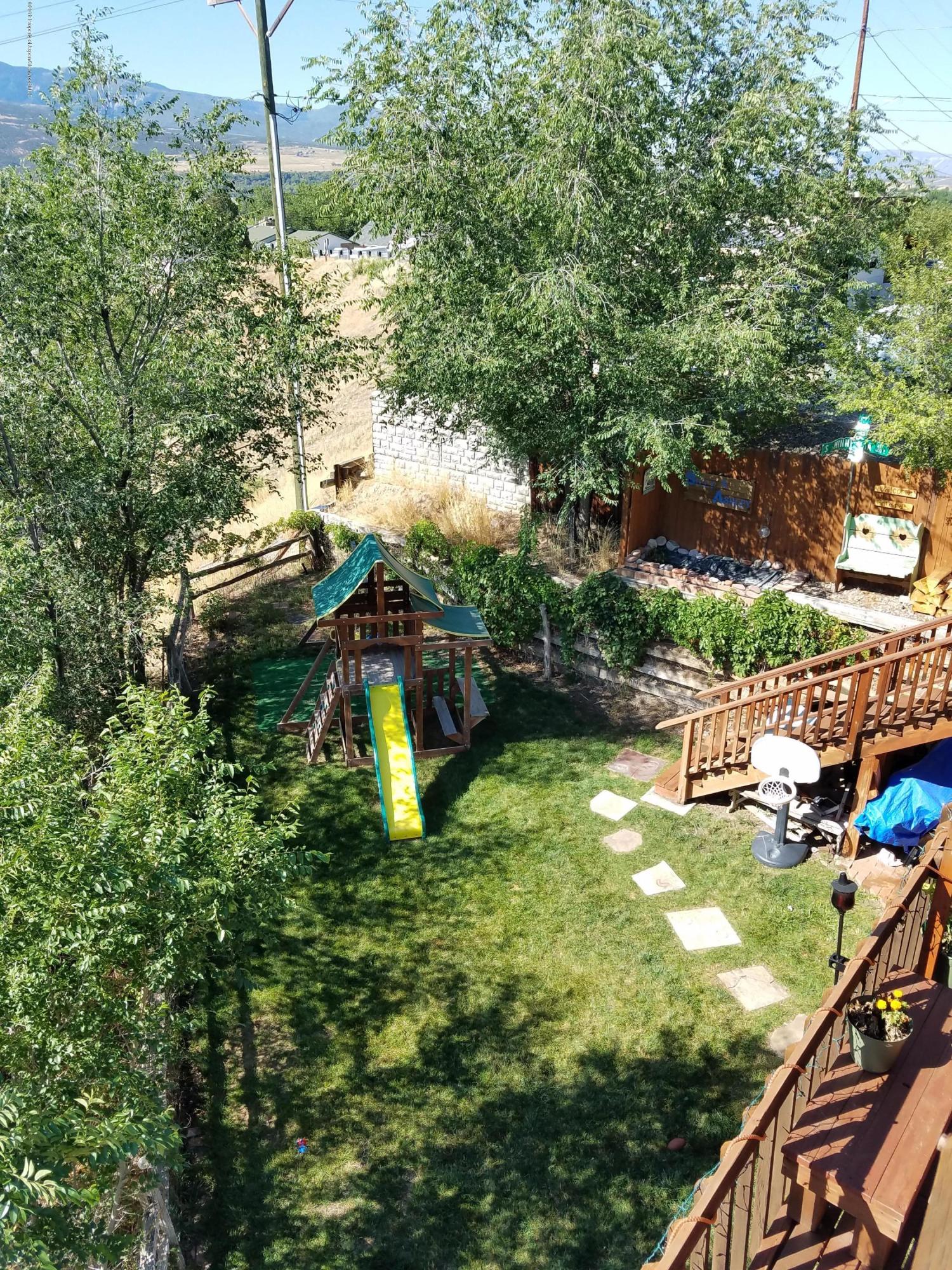 515 East 11th Street Rifle, CO 81650 - Photo 3 of 23 a backyard of a house with lots of green space