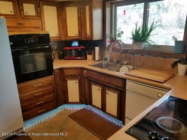 515 East 11th Street Rifle, CO 81650 - Photo 7 of 23 a kitchen with a sink stove and cabinets
