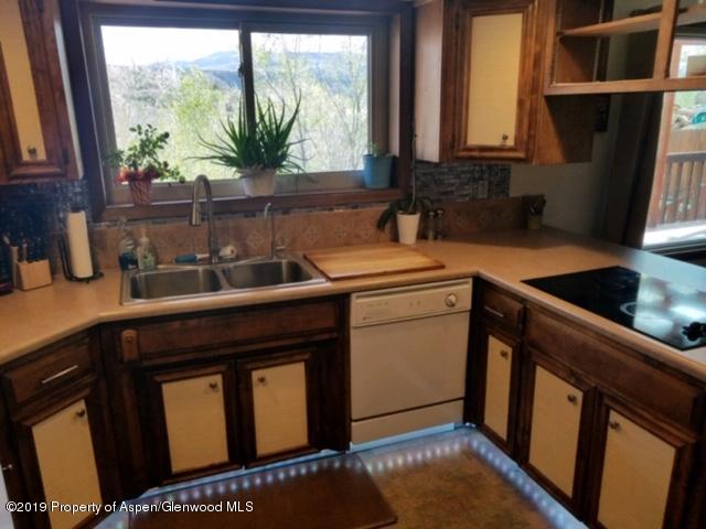 515 East 11th Street Rifle, CO 81650 - Photo 8 of 23 a kitchen with a sink a window and cabinets