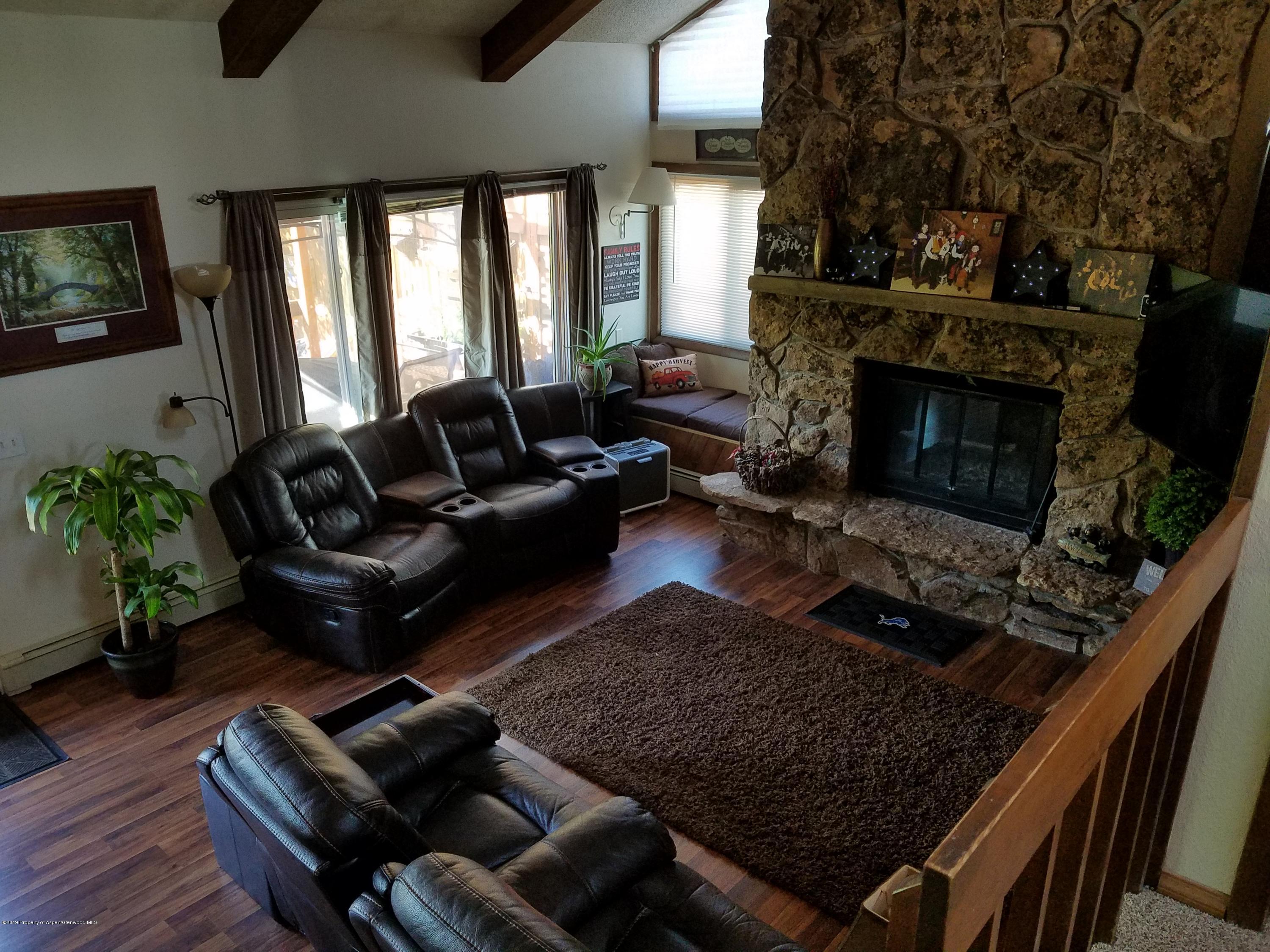 515 East 11th Street Rifle, CO 81650 - Photo 10 of 23 a living room with furniture rug and a fireplace