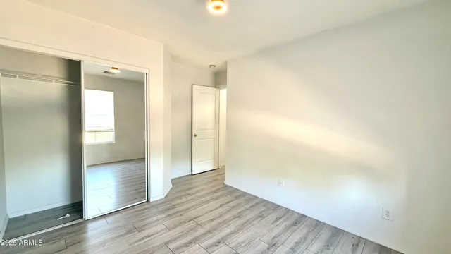 a bathroom with a granite countertop sink toilet and mirror