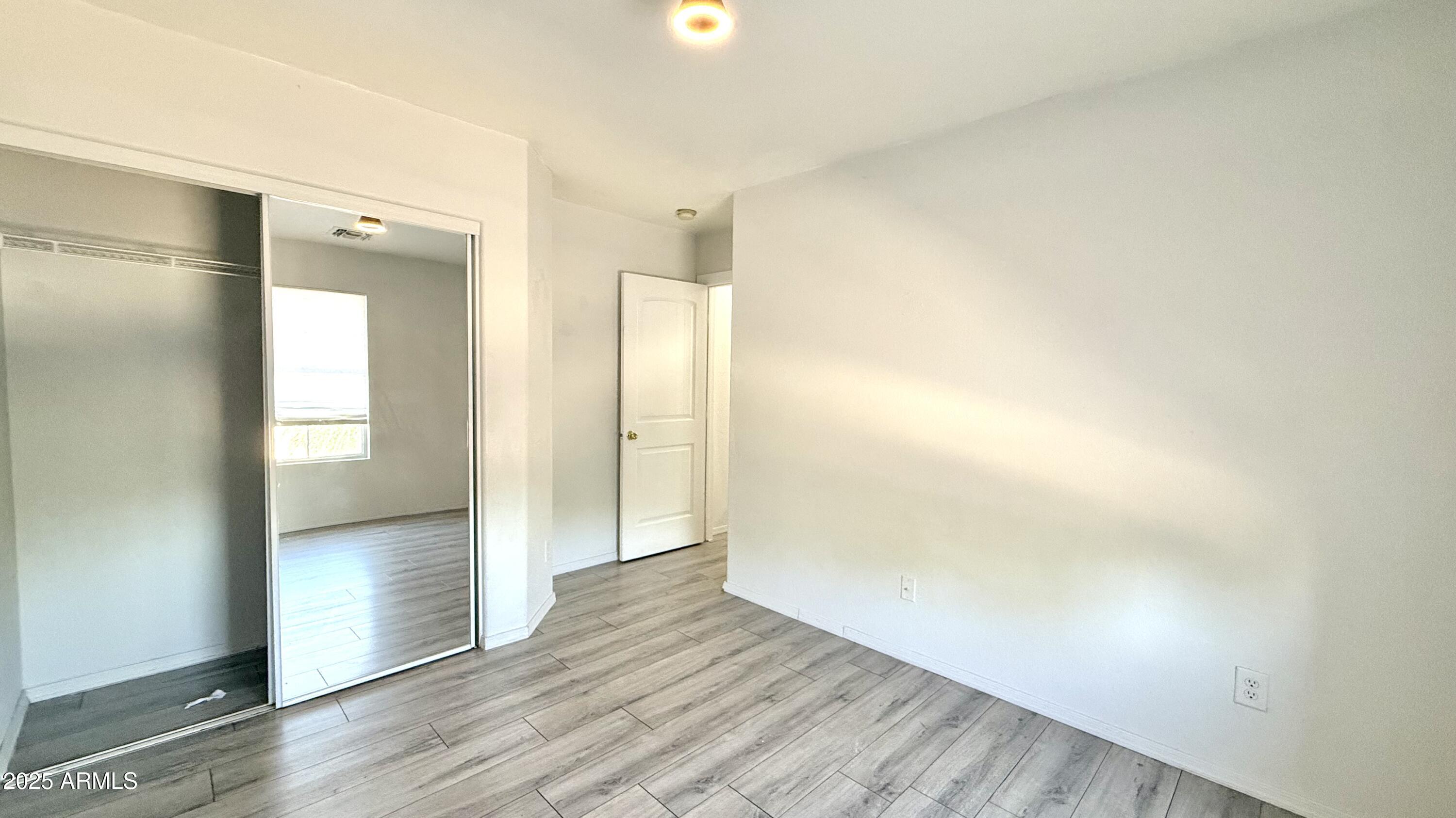 1103 East Grove Street Phoenix, AZ 85040 - Photo 16 of 21 a view of empty room with wooden floor