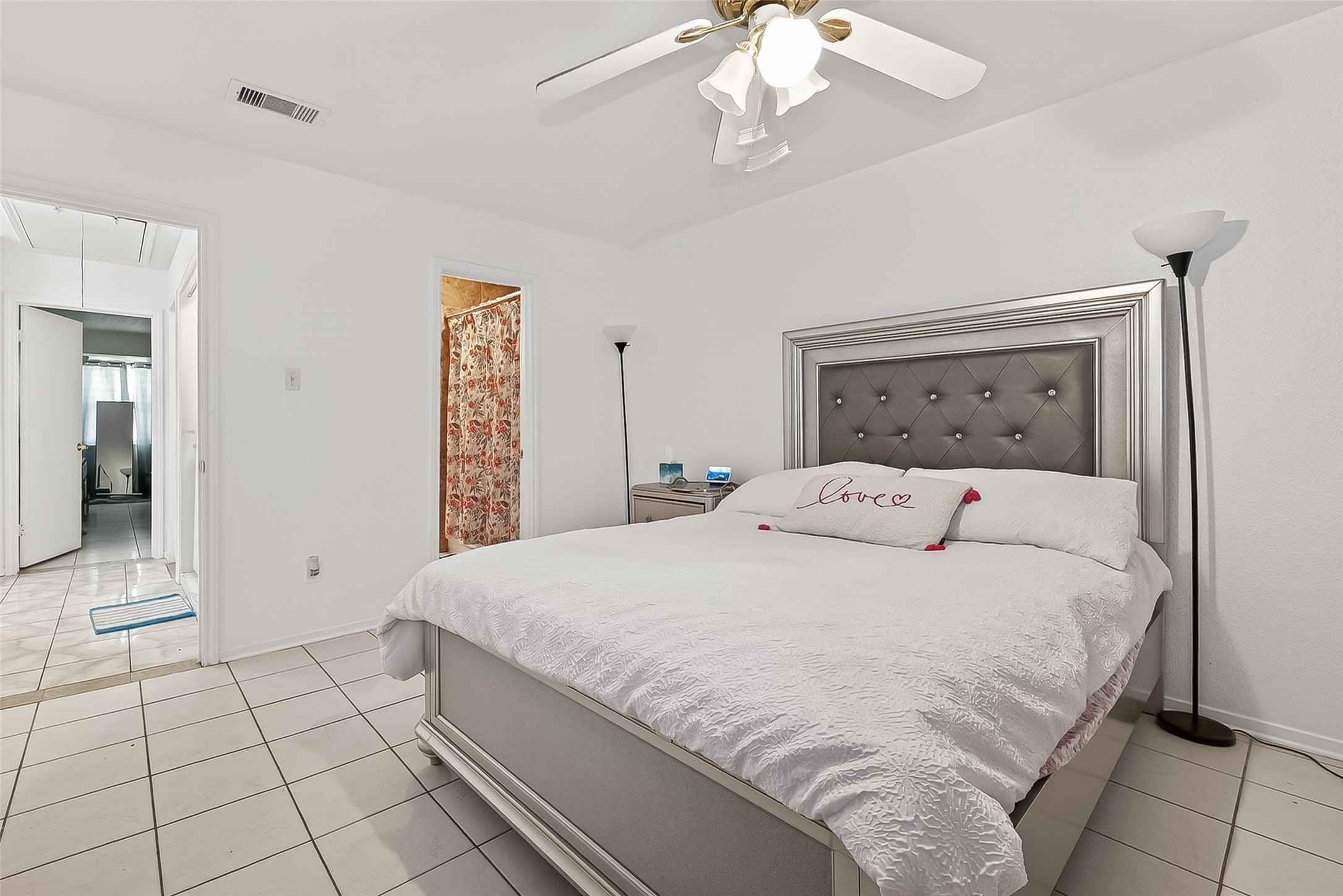 8478 Ariel Street, Unit 61 Houston, TX 77074 - Photo 17 of 27 a bedroom with a large bed and a chandelier