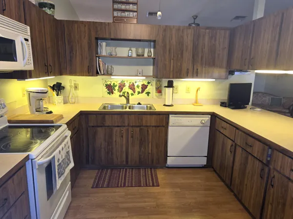a kitchen with a sink and wooden cabinets