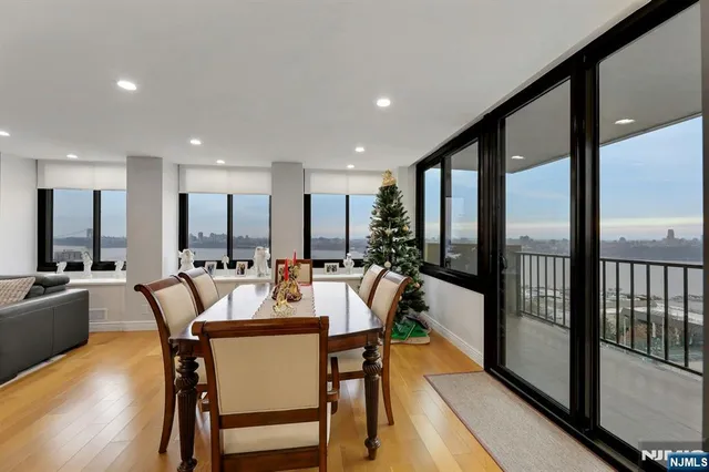 a view of a dining room with furniture a chandelier and wooden floor