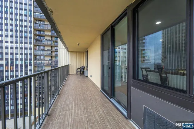 a view of a balcony with wooden floor