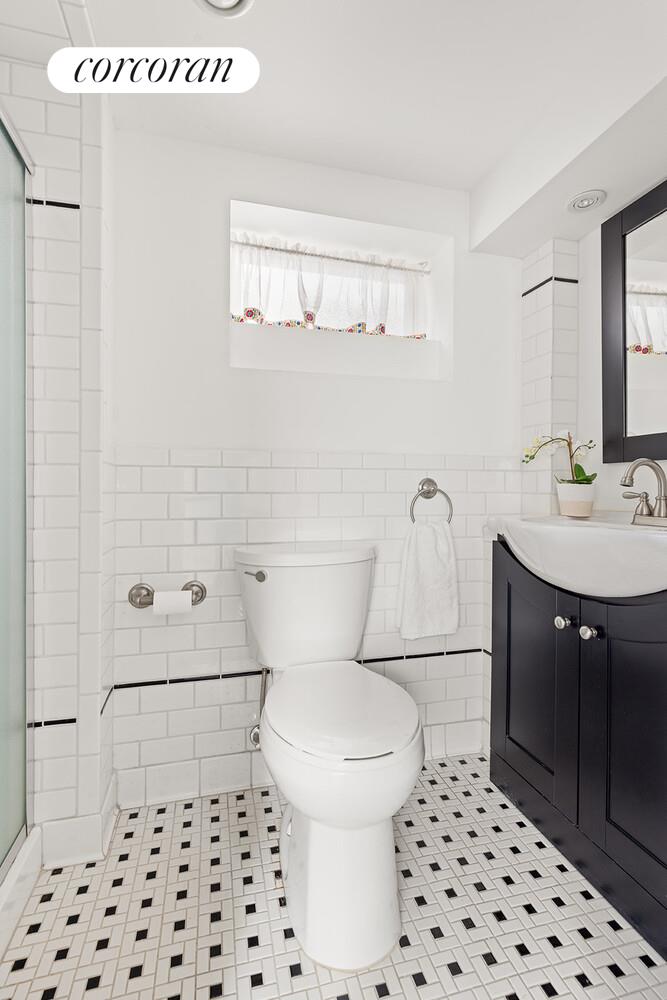 2401 Avenue R Brooklyn, NY 11229 - Photo 13 of 14 a bathroom with a sink a toilet a shower and a mirror