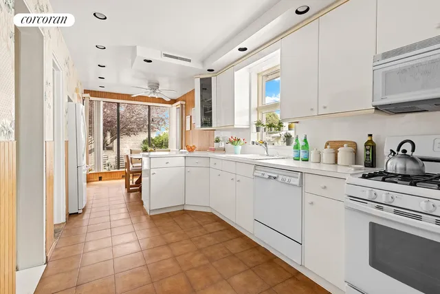 a kitchen with appliances cabinets and a sink