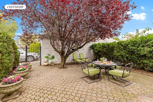 a view of a backyard with sitting area and garden