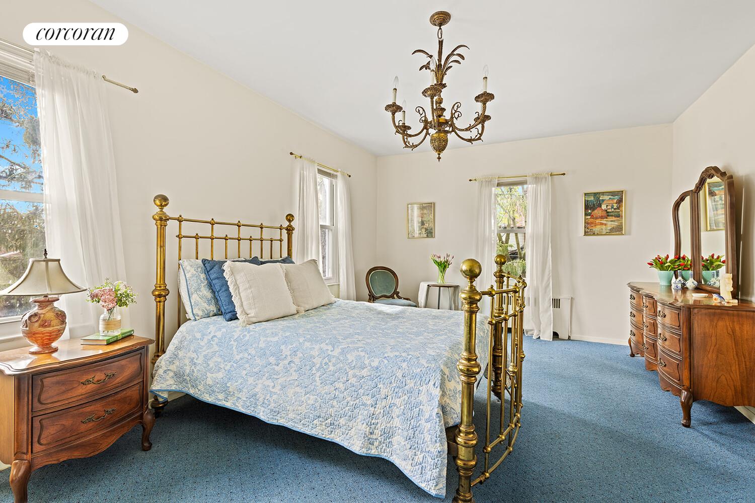 2401 Avenue R Brooklyn, NY 11229 - Photo 8 of 14 a bedroom with a bed and a chandelier