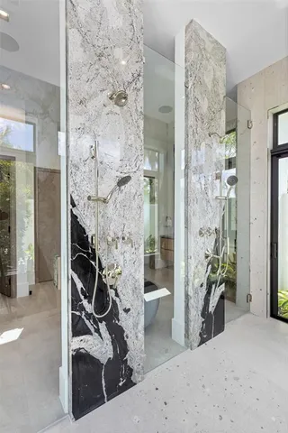 a spacious bedroom with a bed and a large window