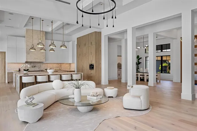 a living room with furniture and a kitchen appliance