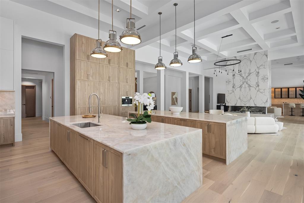12701 Luray Road Southwest Ranches, FL 33330 - Photo 30 of 50 a large kitchen with kitchen island a sink appliances and a counter top space