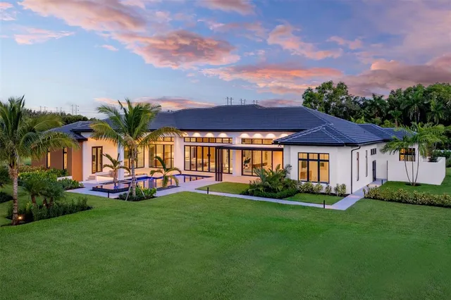 an aerial view of residential houses with outdoor space and swimming pool