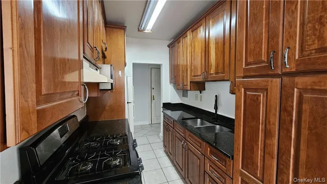 a kitchen with wooden cabinets and a stove top oven