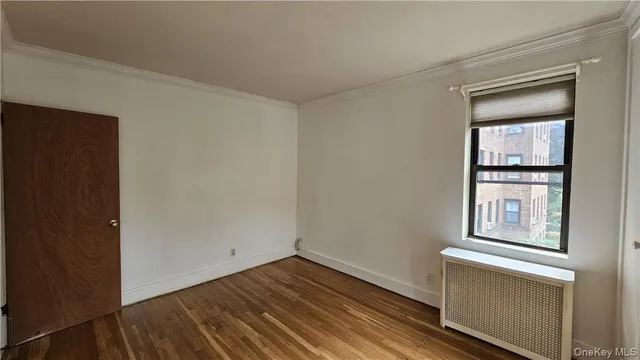 a view of empty room with windows and wardrobe