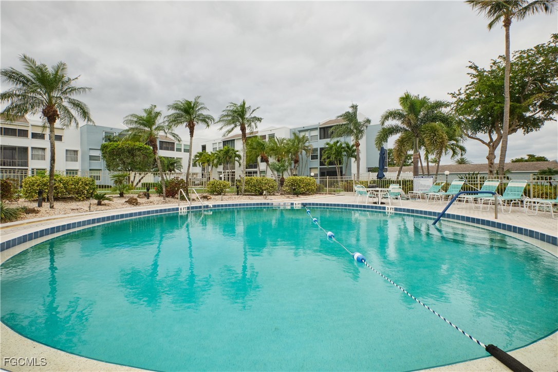 5959 Winkler Road, Unit 118 Fort Myers, FL 33919 - Photo 17 of 22 a view of swimming pool with outdoor seating and lake view