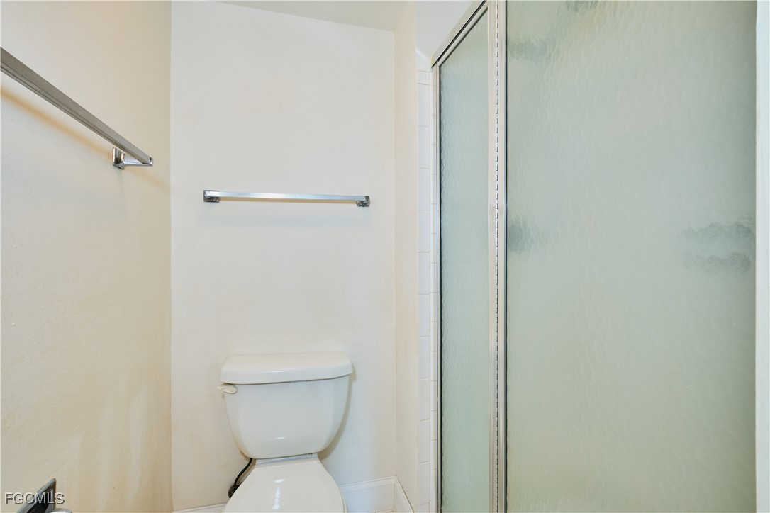 5959 Winkler Road, Unit 118 Fort Myers, FL 33919 - Photo 9 of 22 a bathroom with a toilet and a shower