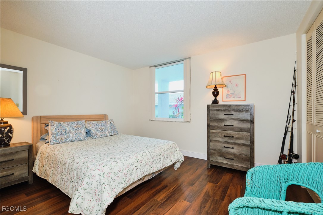 5959 Winkler Road, Unit 118 Fort Myers, FL 33919 - Photo 10 of 22 a bedroom with a bed and a chair