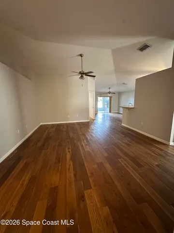 a view of a room with wooden floor
