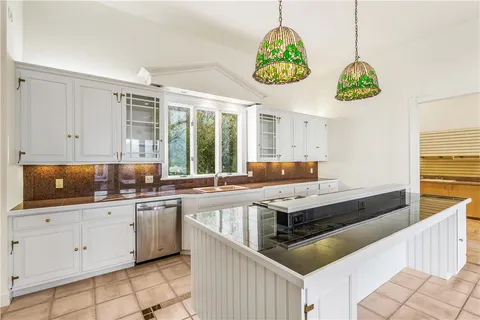 a kitchen with stainless steel appliances a stove a sink and a refrigerator