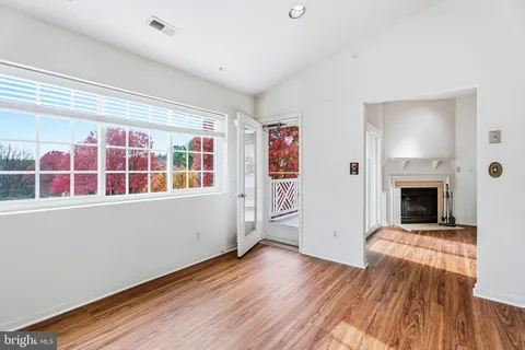 a view of a livingroom with wooden floor and fireplace