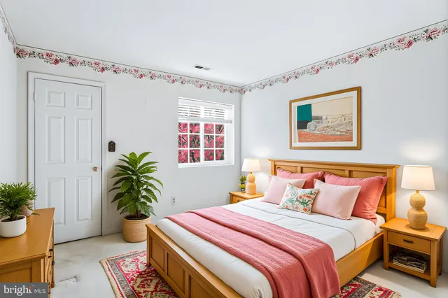 a bedroom with furniture and a potted plant